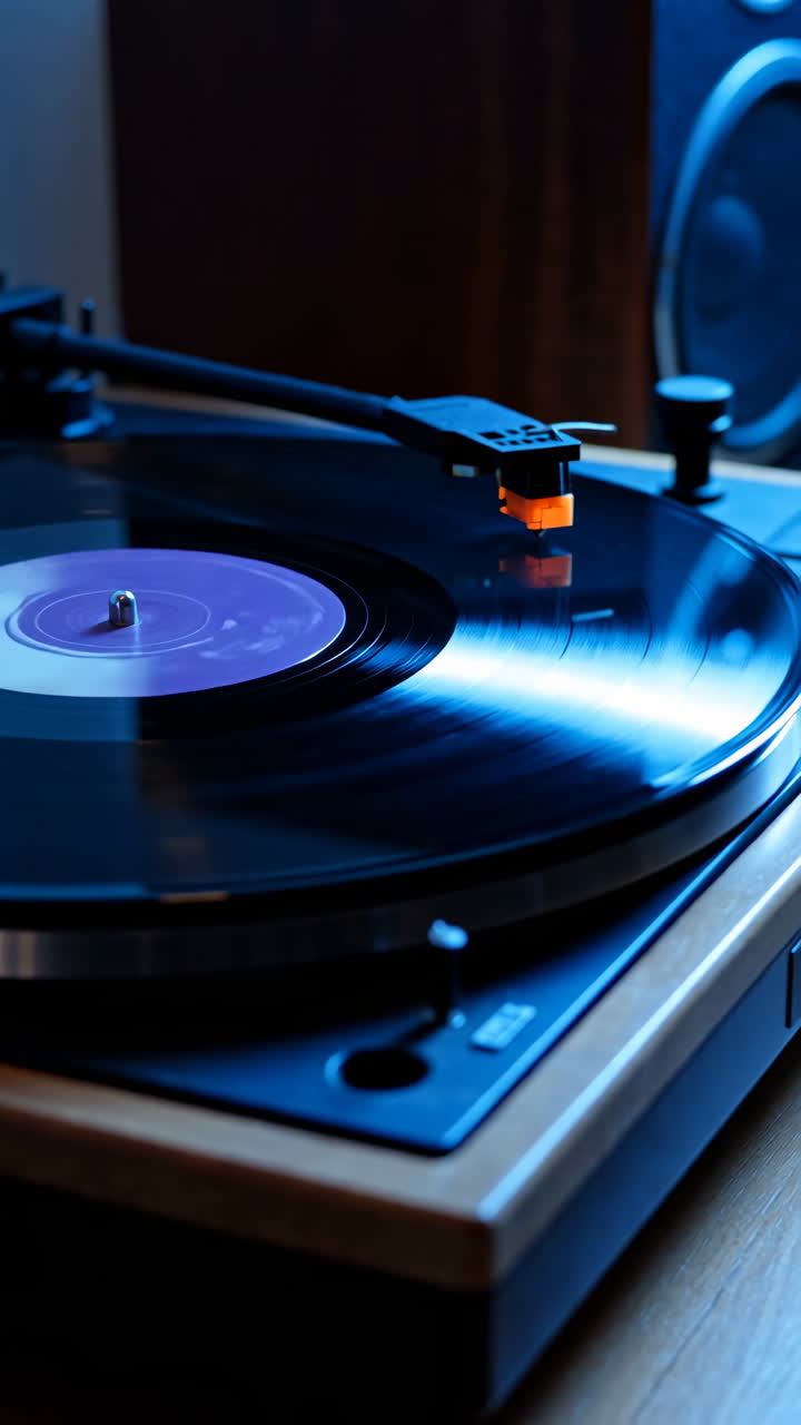 Close-up of a Vinyl Record Spinning on a Turntable with Blue Lighting