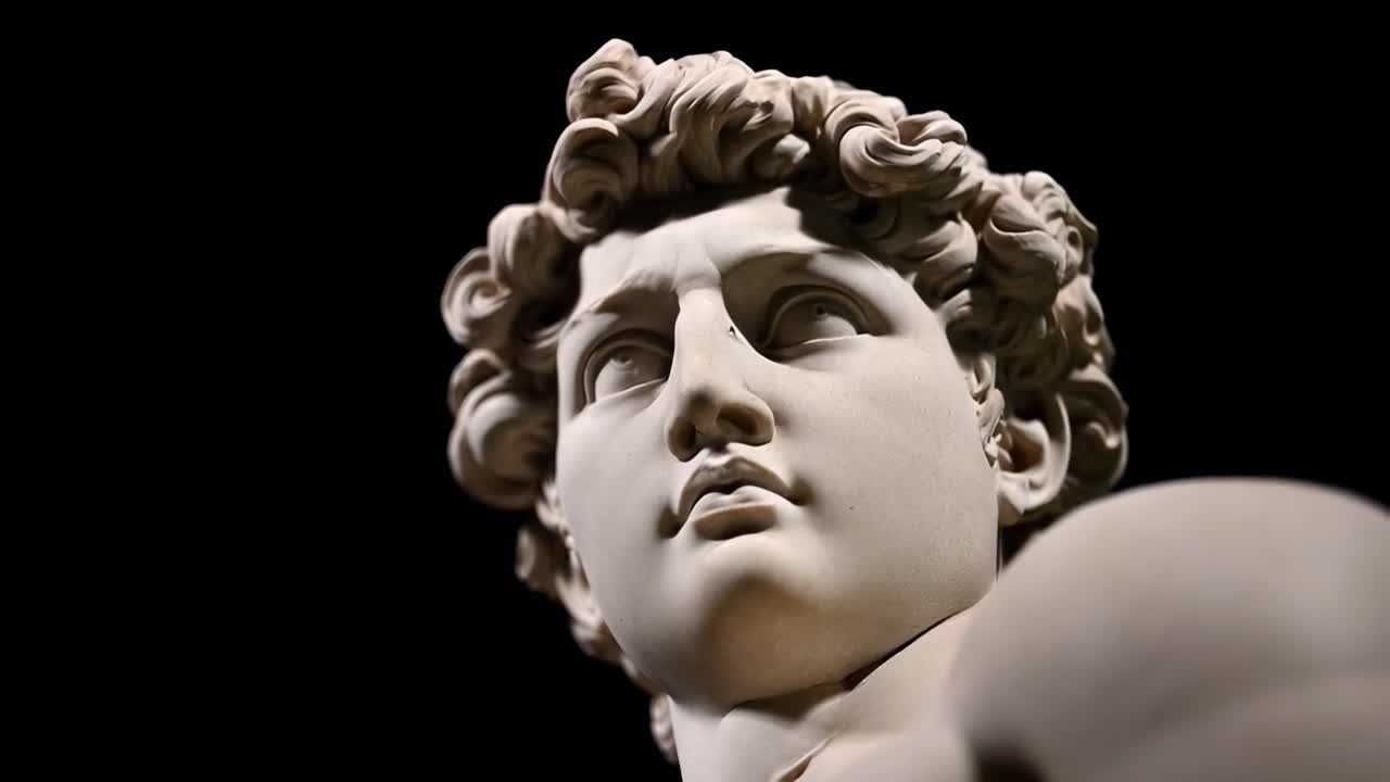 Close-up video angle of a classical marble statue's face, highlighting intricate details