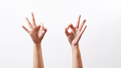 hand showing ok thumbs up scissors victory chroma key isolated on a white studio background with copy space for place a text for advertisement