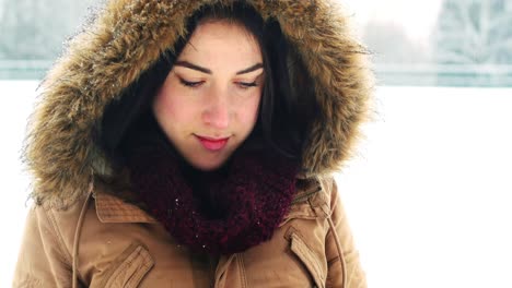 woman in fur jacket using mobile phone