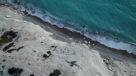 Coastline-aerial-top-down-view-nature-landscape,-pure-blue-sea-water-with-waves-at-rocky-coast-in-Ayia-Napa,Cyprus