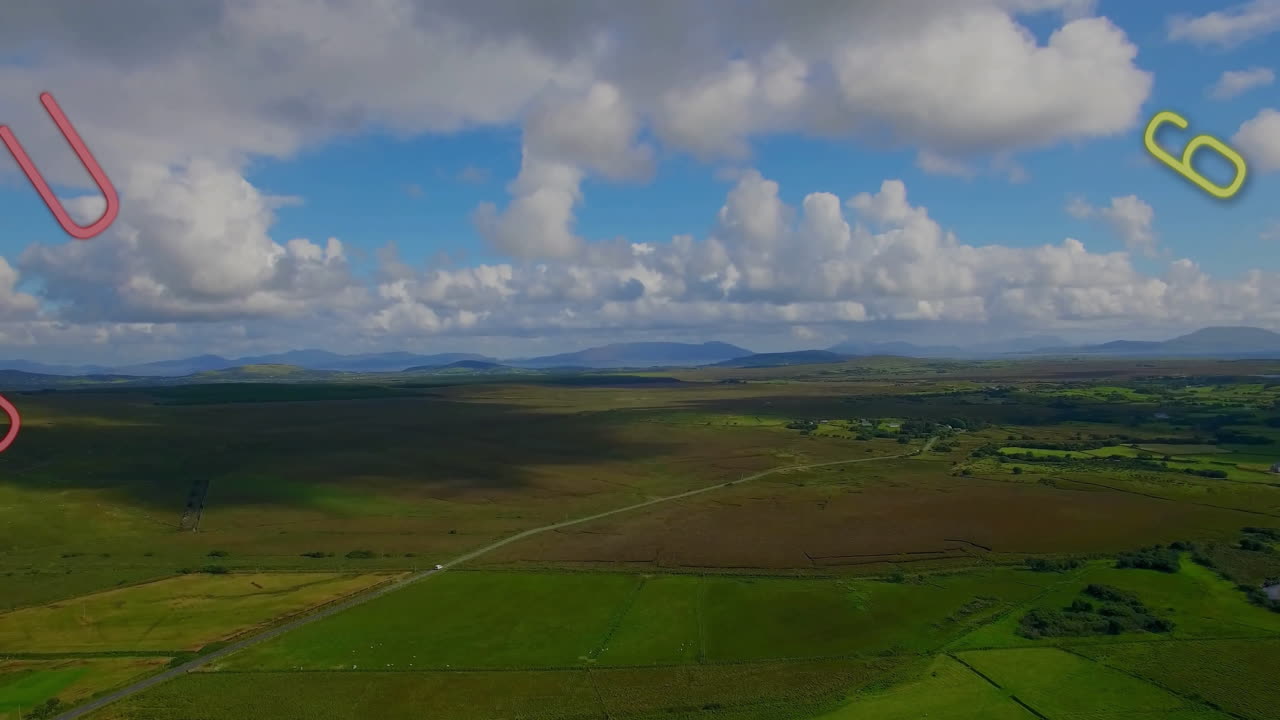 Clouds casting shadows over vast green landscape with colorful lines animation