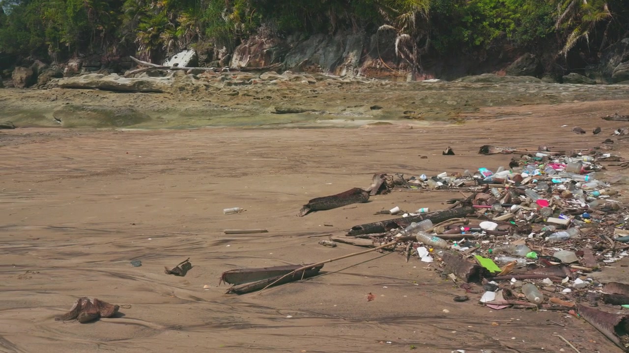 Large amounts of rubbish washed up on a tropical beach in Bako, Borneo