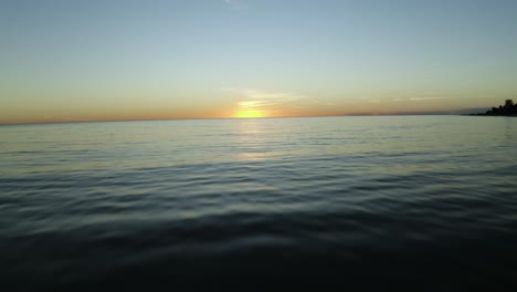 flying over the ocean at sunset 4k