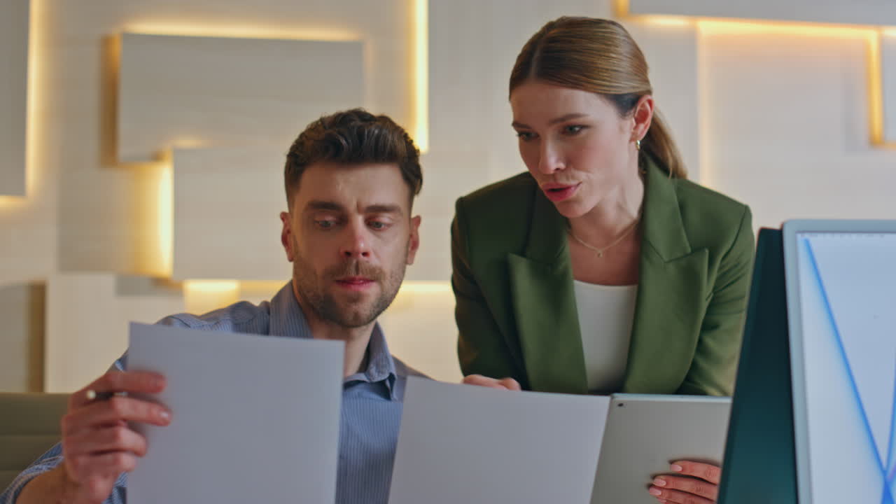 Creative workers brainstorming office looking at papers close up. Two designers