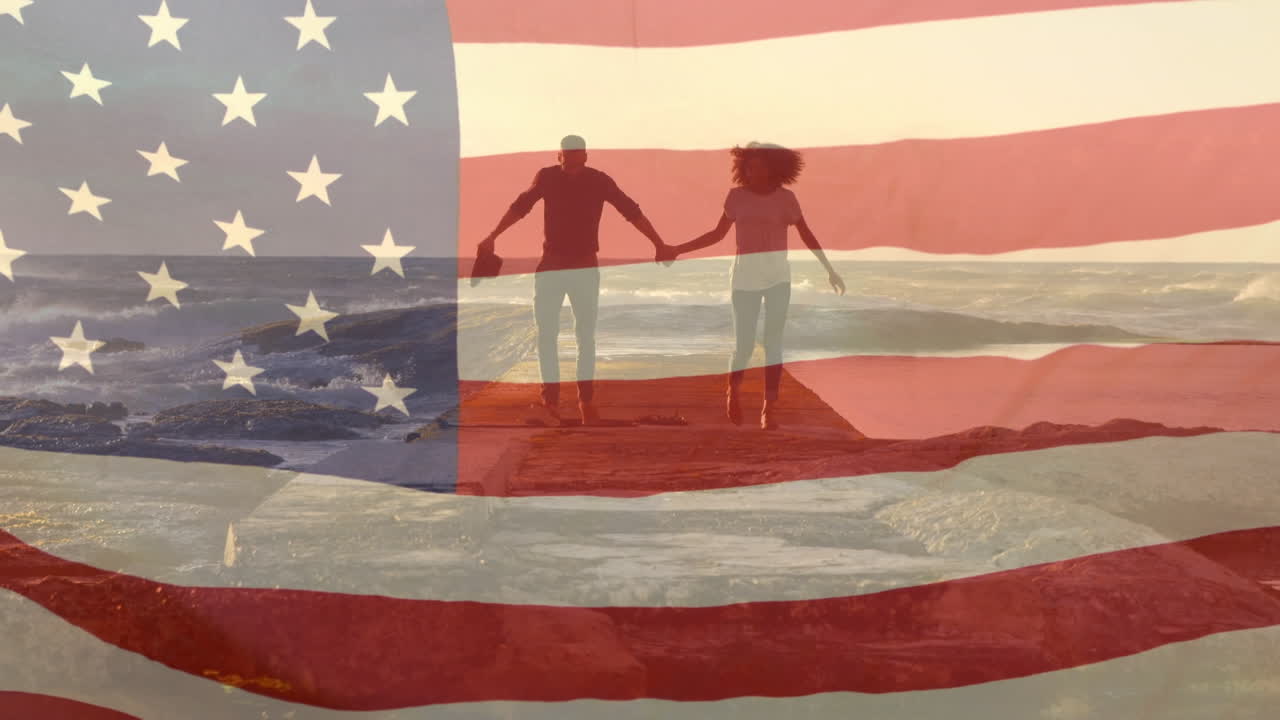 animación de la bandera de los estados unidos sobre una pareja afroamericana en la playa
