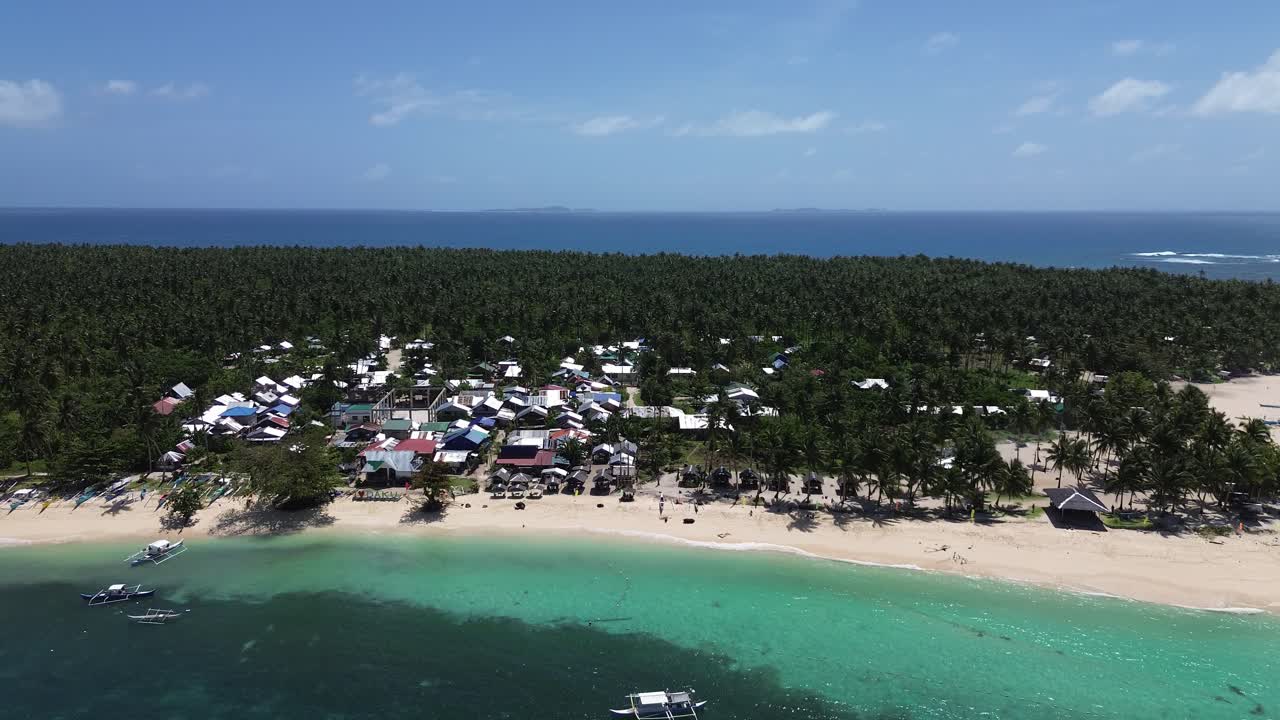 Aerial view of a small island community by the beach with ocean in the background