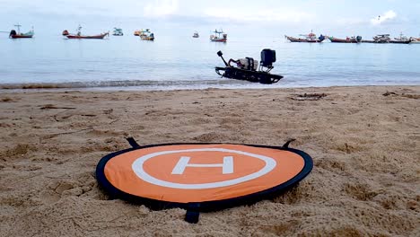 fpv drone lift up from landing pad on the beach on super slow motion