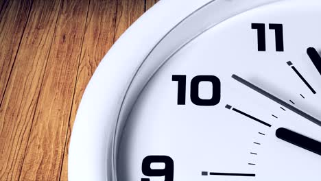 close up of a wall clock showing 10 am with wooden background