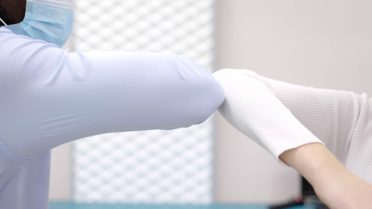 People Elbow Bumping During Social Distancing