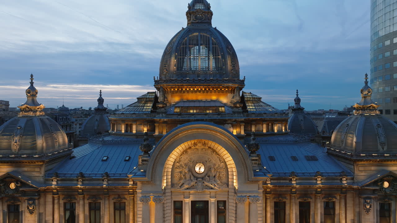 Aerial drone view of the illuminated Palace of the Deposits and Consignments in the evening. Blue hour in Bucharest, Romania