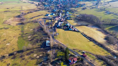 overhead view of quaint hamlet surrounded by early spring hues