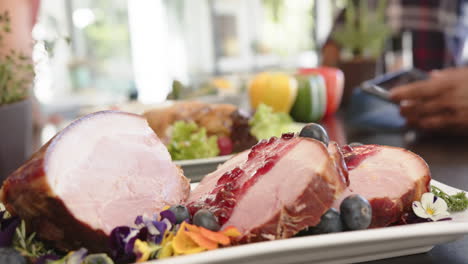 Dishes-of-prepared-food-on-kitchen-counter-of-friends-celebrating-christmas-at-home,-slow-motion