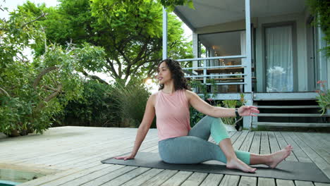 woman practicing yoga on deck, enjoying peaceful outdoor setting at home