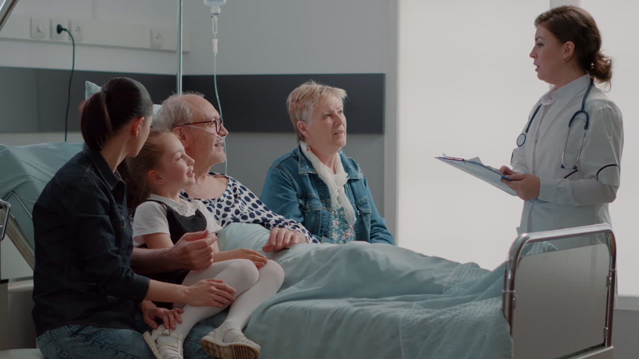 Medic explaining diagnosis to old patient and family in visit