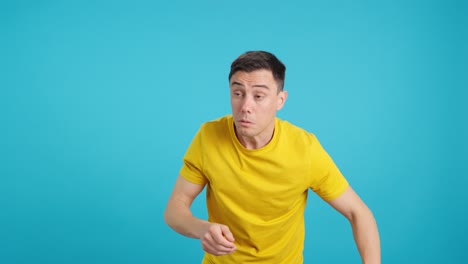Shocked man in yellow shirt