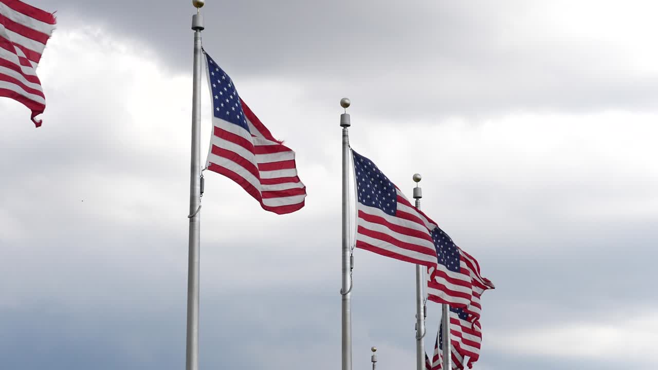 Close up of American flags at the Washington Monument located in Washington DC in the USA
