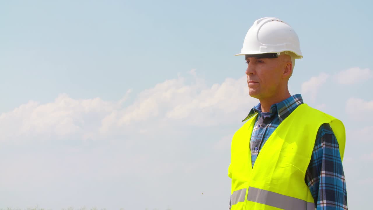 Ingegnere che legge una planimetria e lavora a un parco eolico di energia alternativa 1