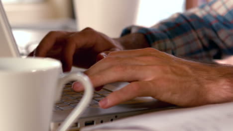 Casual-businessman-working-on-his-laptop