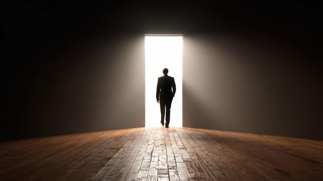 A silhouetted figure in a suit walks towards a bright doorway, symbolizing opportunity, hope, and the journey of self-discovery through dark spaces into illuminated futures
