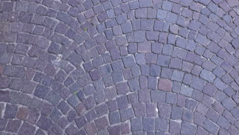 footsteps on cobblestone street in naples, italy