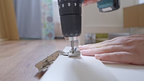 detailed white closet assembly using electric screwdriver close-up