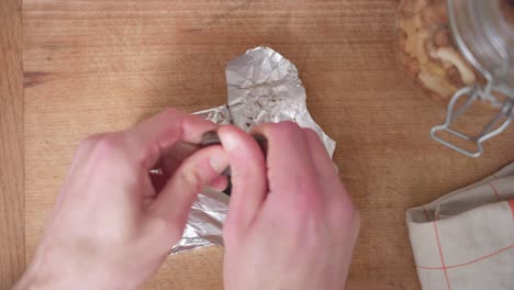 zenithal shot of a person breaking chocolate from a chocolate bar