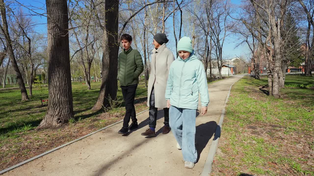 Family Walking Together on a Sunny Day in the Park