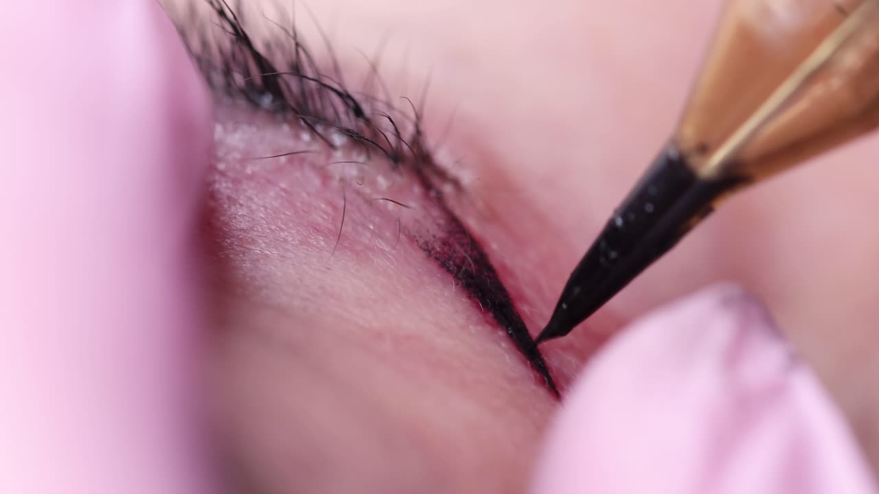 Tattoo artist applying black arrows to woman with machine 4k movie
