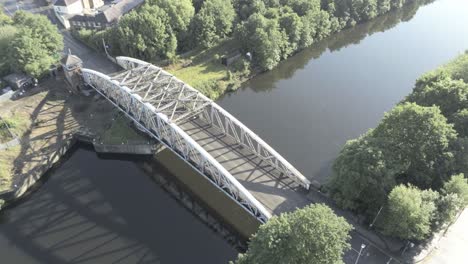 aerial birds eye view scenic old vintage steel archway car crossing footbridge over manchester ship canal