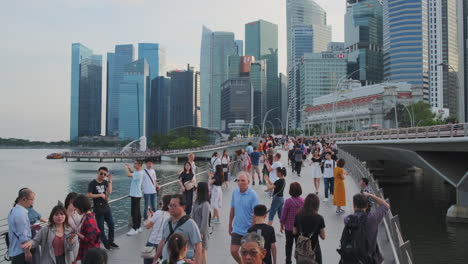 singapore marina bay bridge with skyscrapers and people