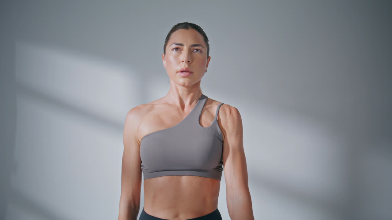 Sportswoman training hands strength lifting dumbbells at studio. Woman workout