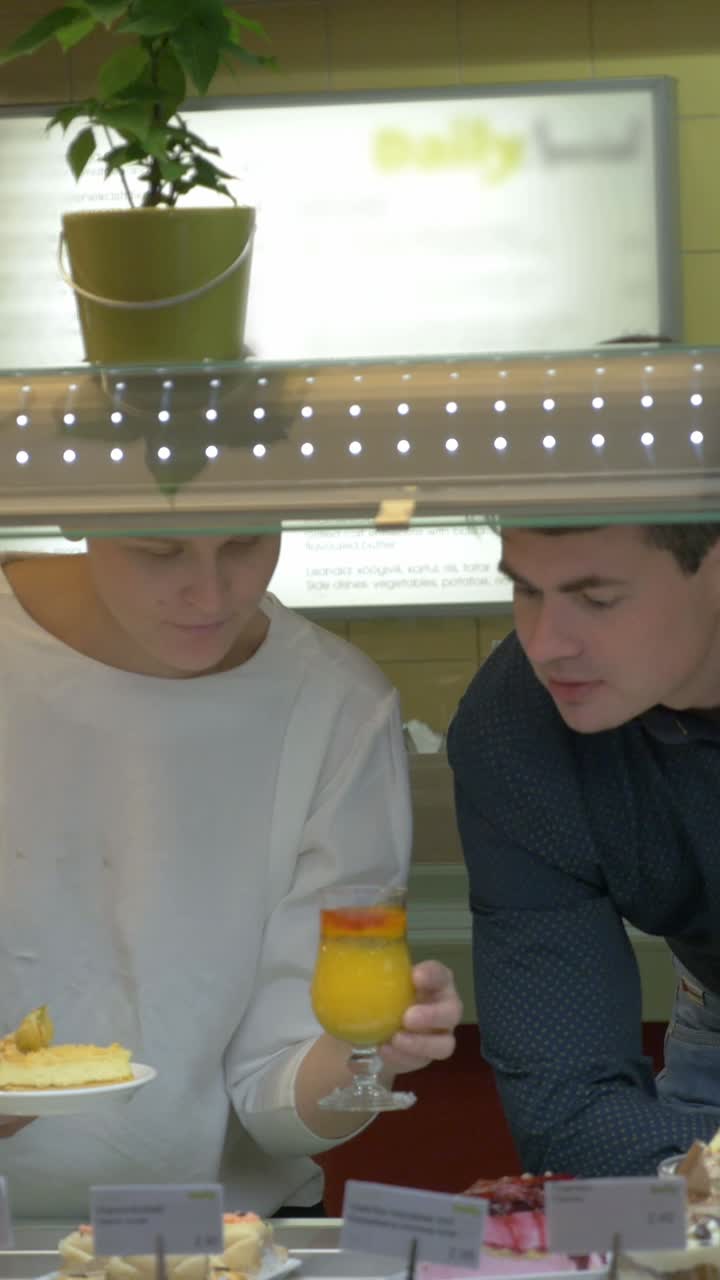 People looking at food display