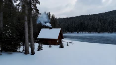 winter cabin by frozen lake