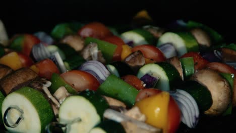 chef brushing olive oil on bbq vegetable kebabs