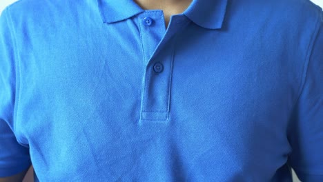 man buttoning his shirt close up