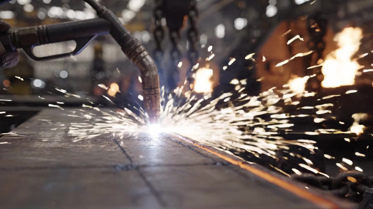 Explosive Sparks and Precision Welding: A Close-Up of Metallurgical Work in a Manufacturing Facility with Flames and Intense Heat Production