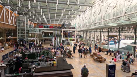 crowds and activity at paddington station, london