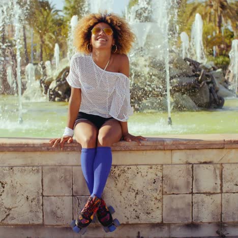 happy sexy girl sitting on fountains wall