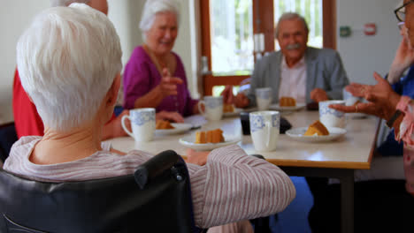 group of mixed-race senior friends eating breakfast on dining table 4k