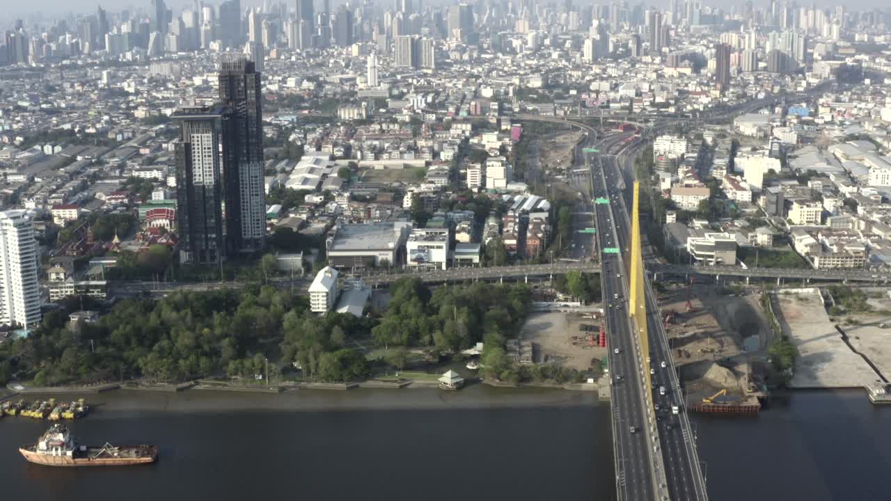 Bhumibol Bridge Over The Chao Phraya River With City Skyline Of Bangkok, Thailand.- aerial shot