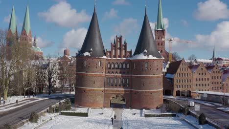 aerial view of the holsten gate in lübeck after snowing