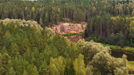 gauja national park. 4k aerial drone footage revealing devonian rock formations preserved for millions of years in the baltic wilderness of latvia. a major tourist attraction in northern europe.