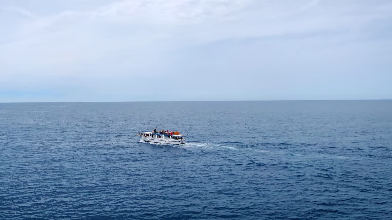 Aerial view of a boat sailing across the Aegean Sea near Malia coast in Crete, Greece