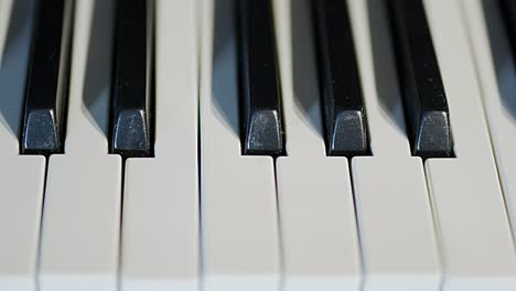 piano keys in a close up, left to right, fast, tracking shot