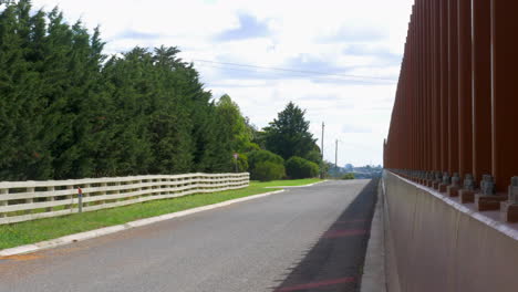 pan right, noise reduction steel wall beside a property