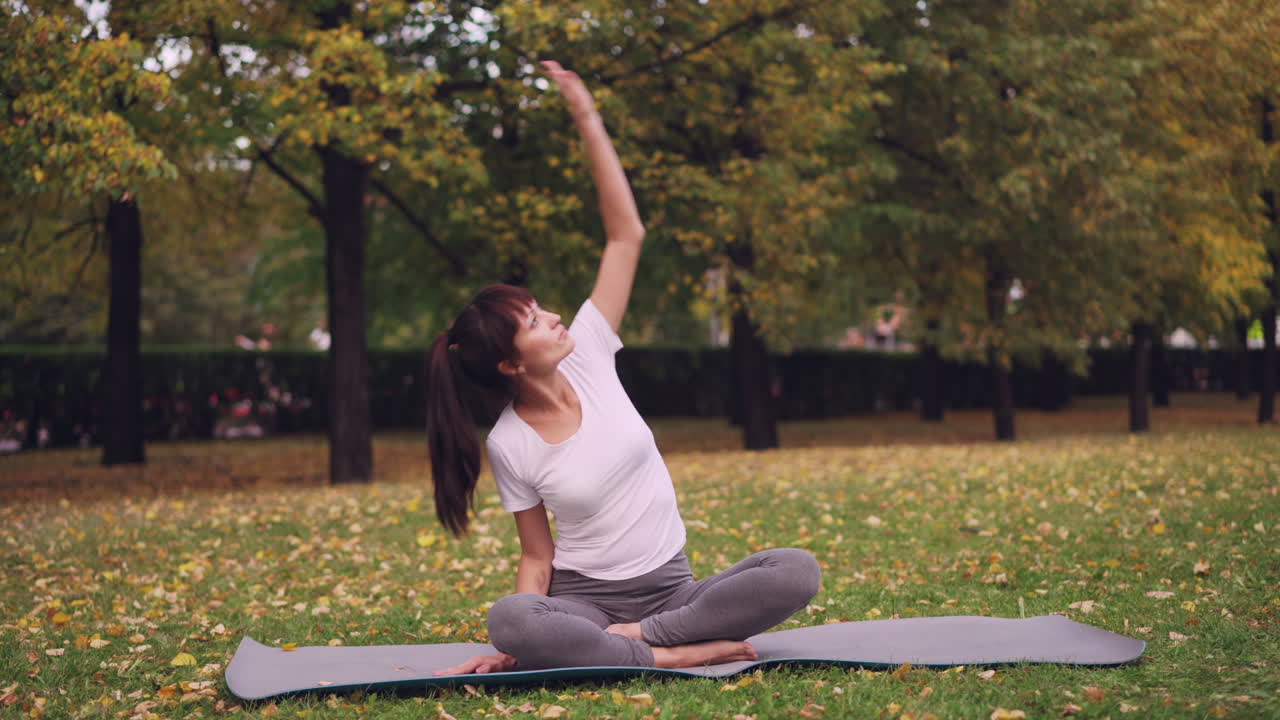 Woman Practicing Yoga in Autumn Park