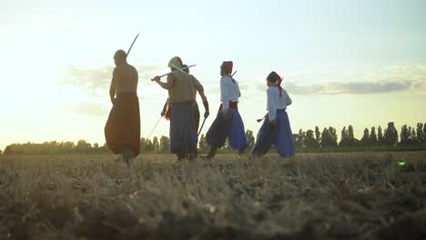 group of cossack men in traditional clothes swinging and spinning sharp shashkas 02