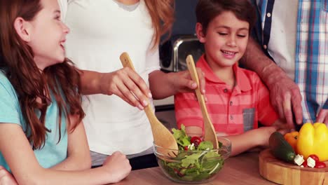 happy family preparing salad together