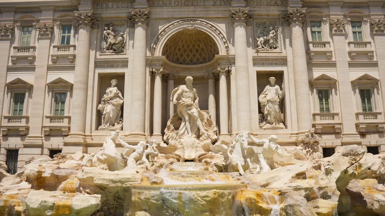 Trevi District, Rome, Italy - The Iconic Trevi Fountain, Distinguished by its Stunning Baroque Architecture - Pan Down Shot